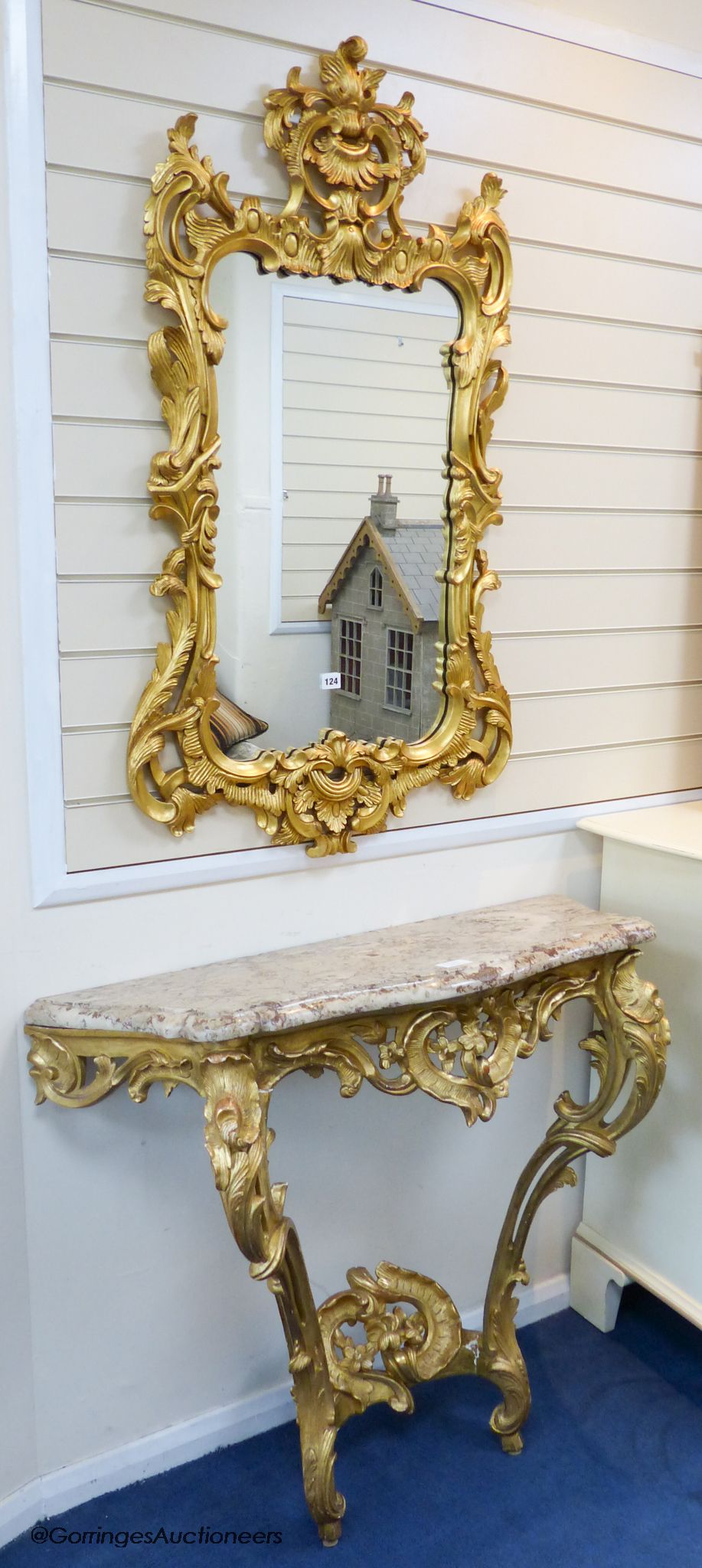 A 19th century rococo revival giltwood console table, 95cm wide, 86.5cm high and a similar later giltwood mirror, 113cm high, 64.5cm wide